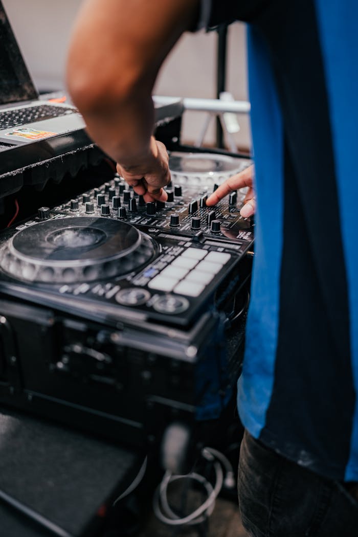 Close-up of a DJ mixing music with equipment, setting the club vibe.