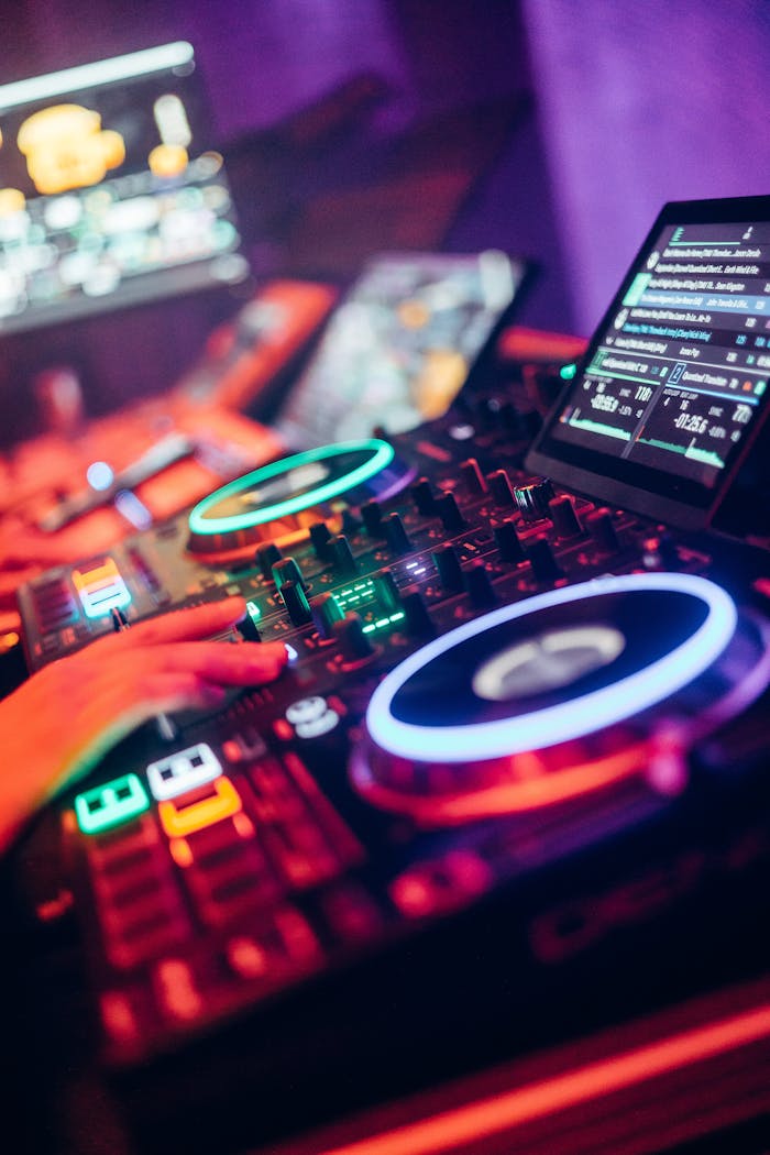DJ equipment with illuminated turntables and neon lights creating a vibrant nightclub atmosphere.