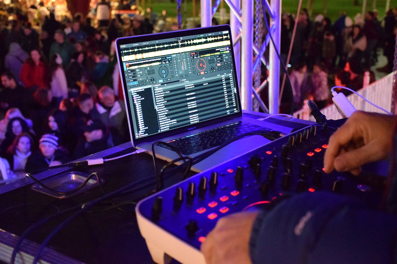 Vibrant outdoor night DJ performance with an engaged crowd and professional equipment.